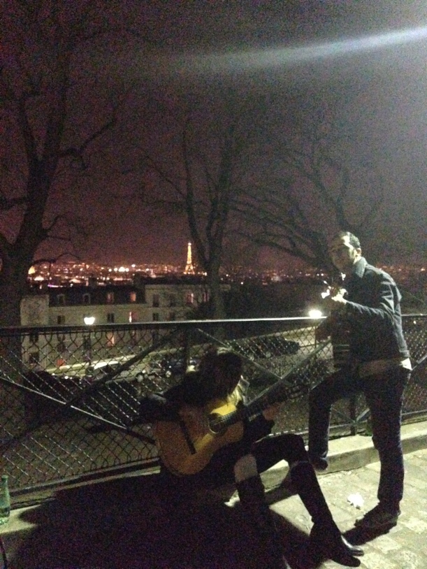 Me, playing guitar with my new friend, Eiffel Tower in the distance.
